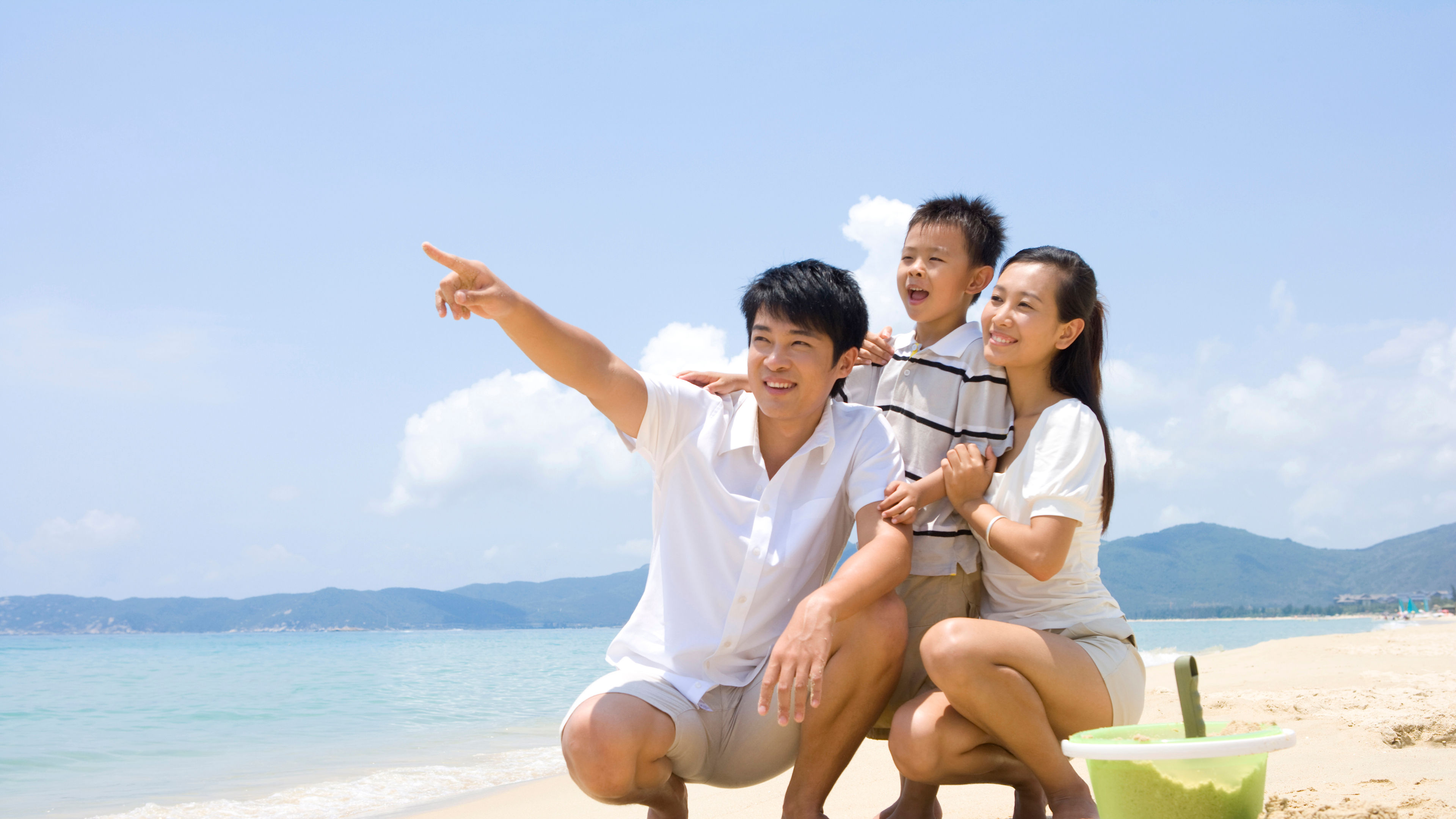 A happy family playing on a beach  