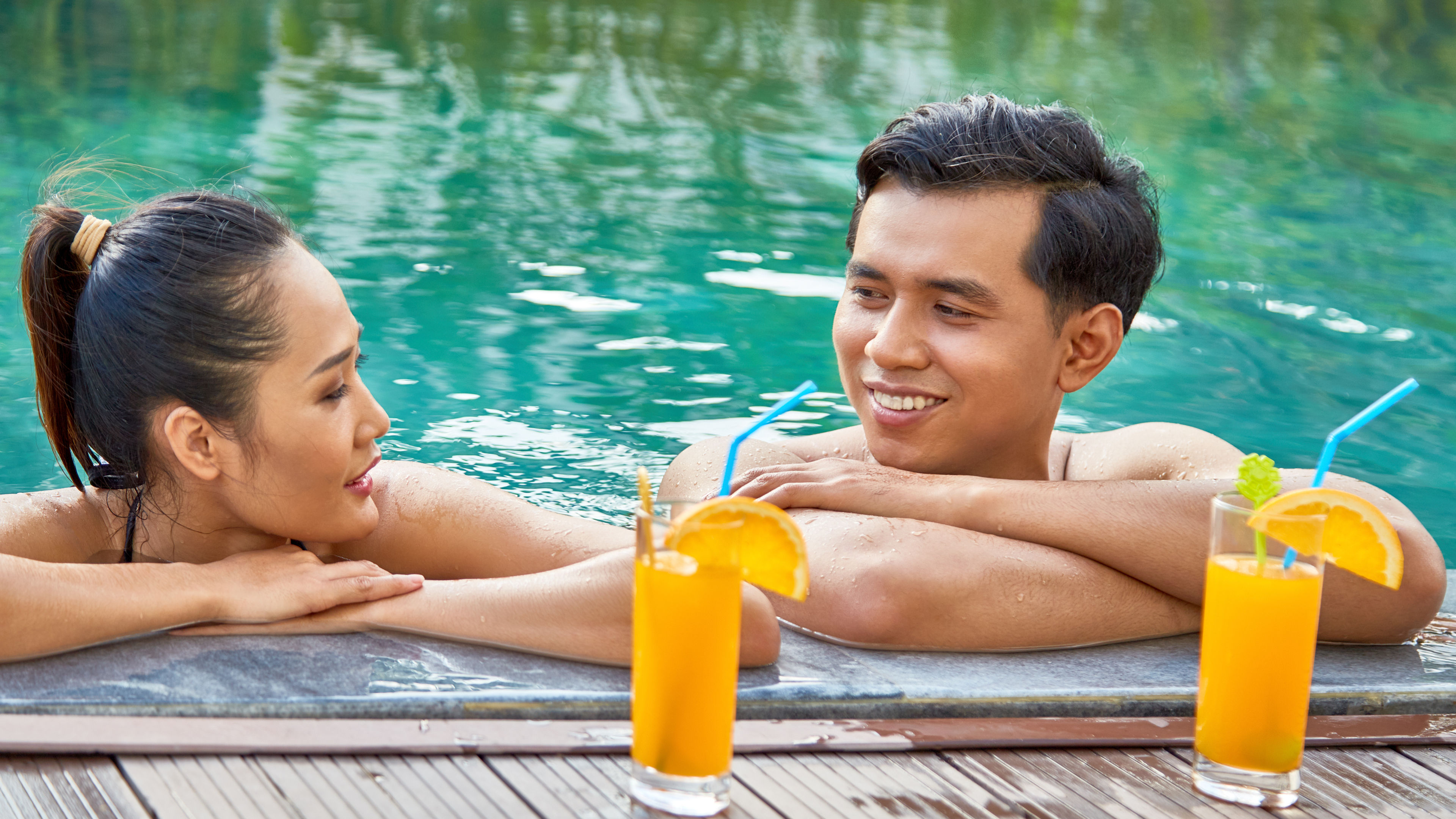 Image of a happy couple in a swimming pool. 