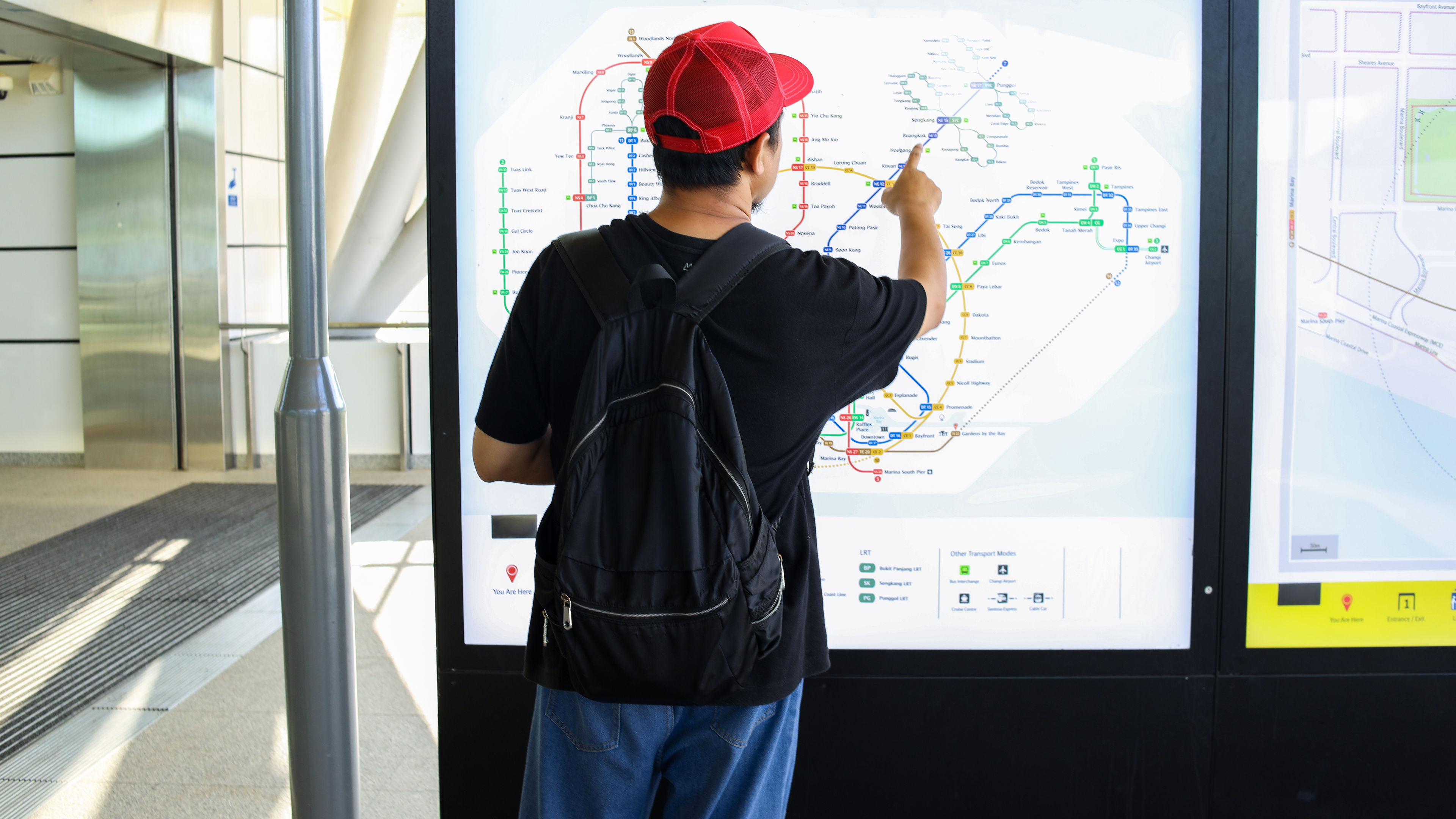 Image of a man looking at electronic map/paper 