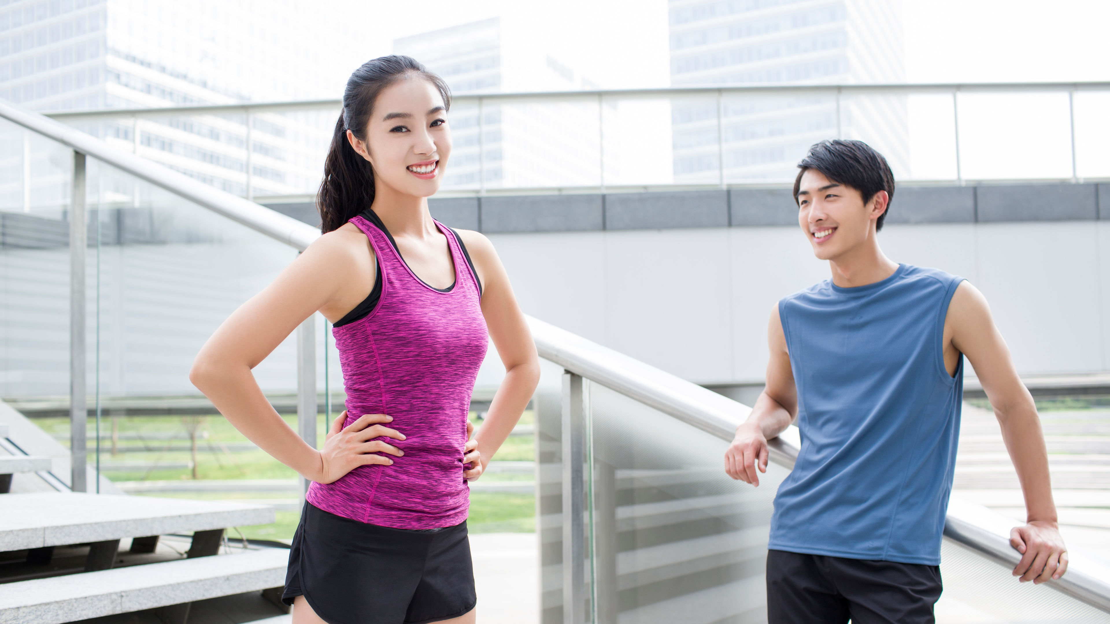 Young couple resting on the stairs after exercise