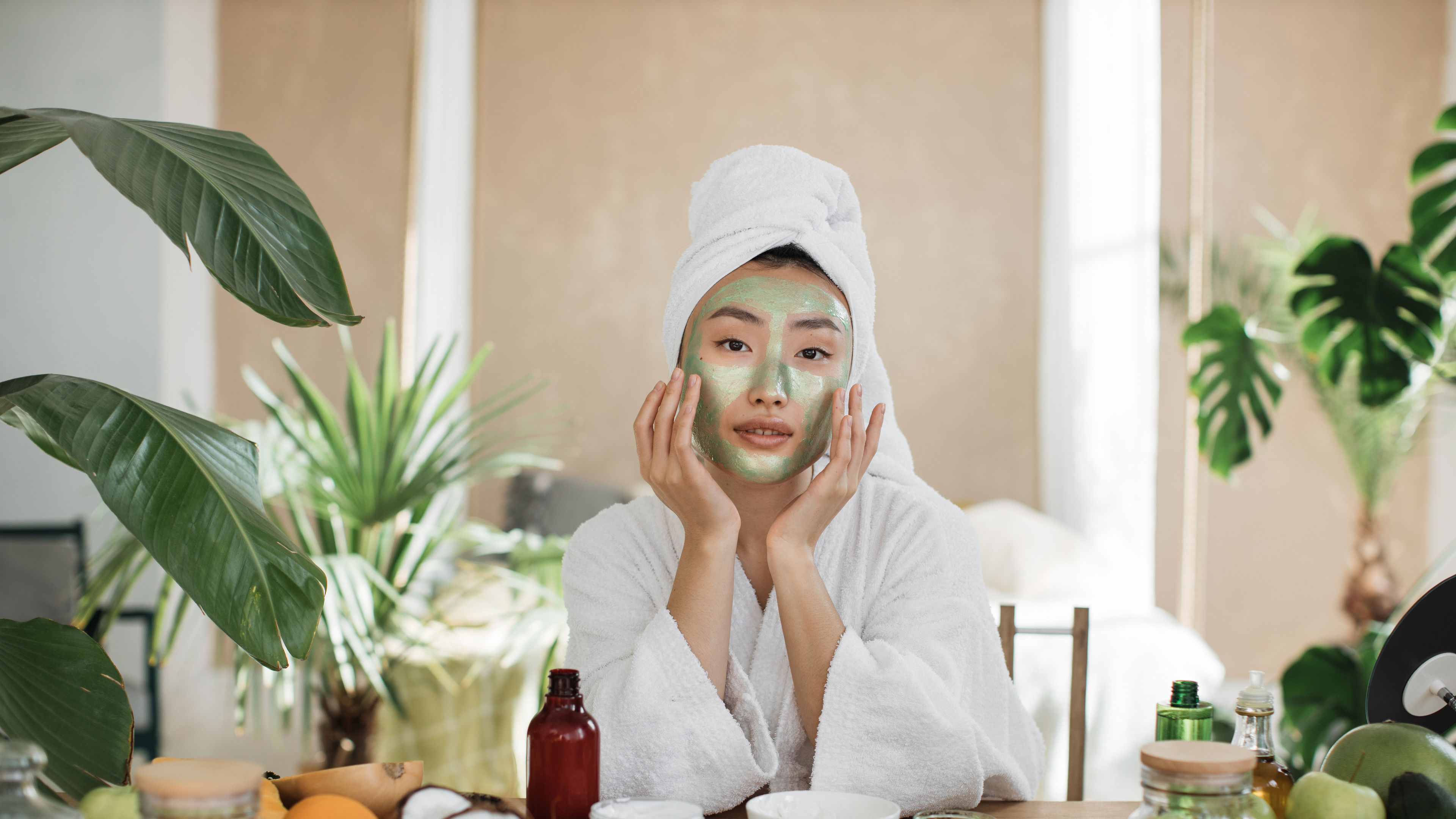 A young woman applies a refreshing face mask made with natural ingredients.  